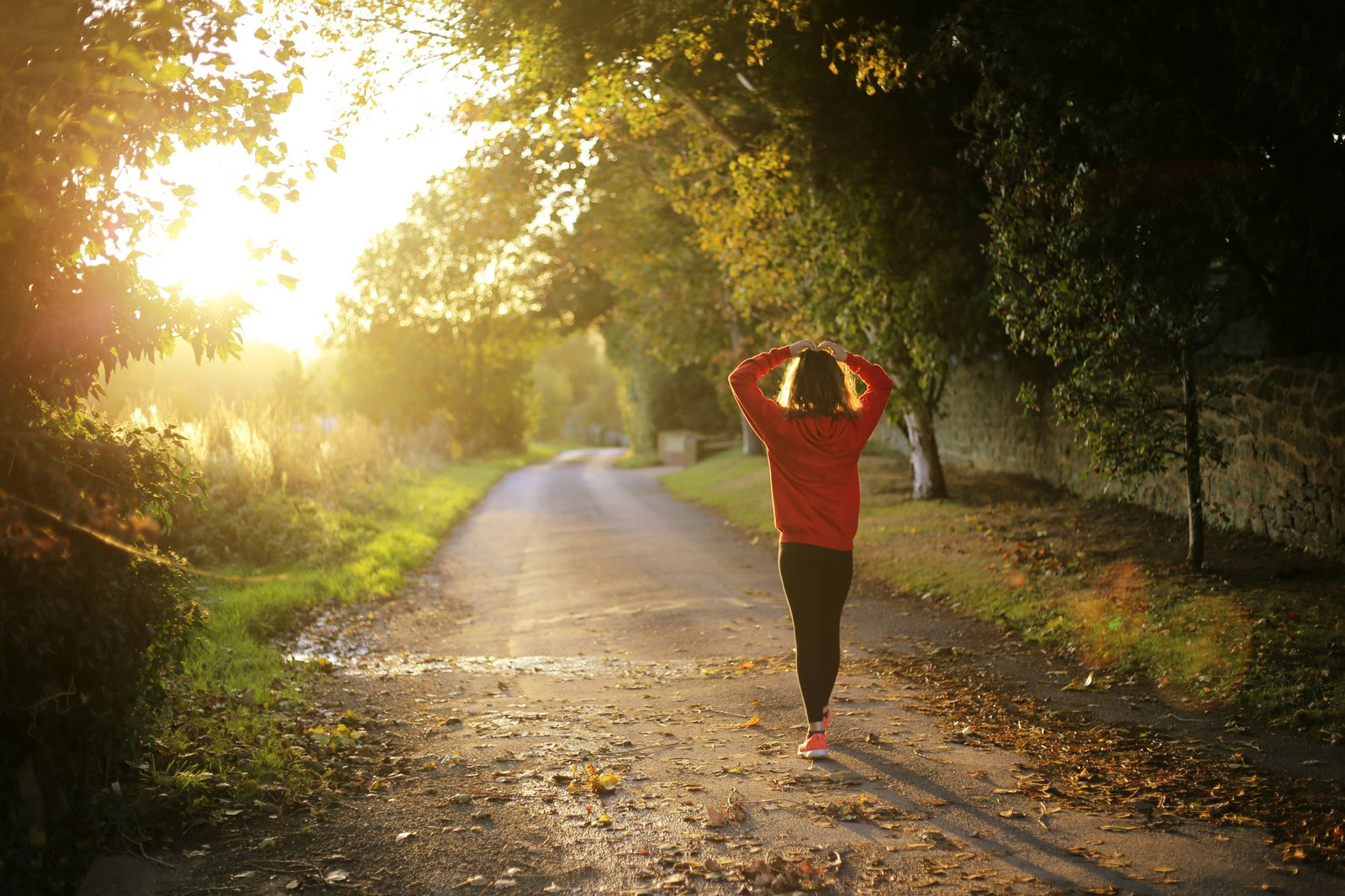 Woman stretching on a sunlit morning walk