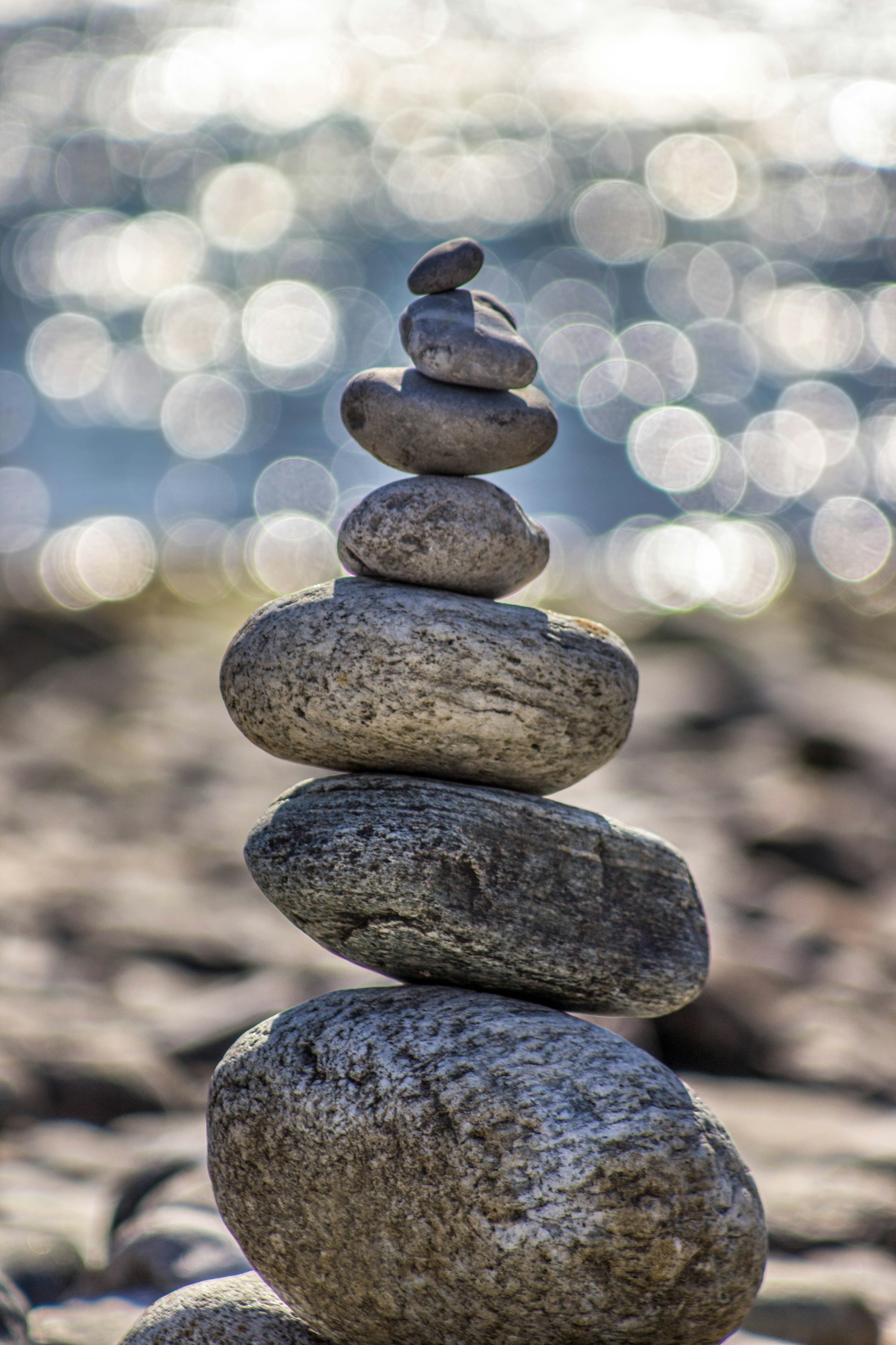 Seven stones balanced with light ripples