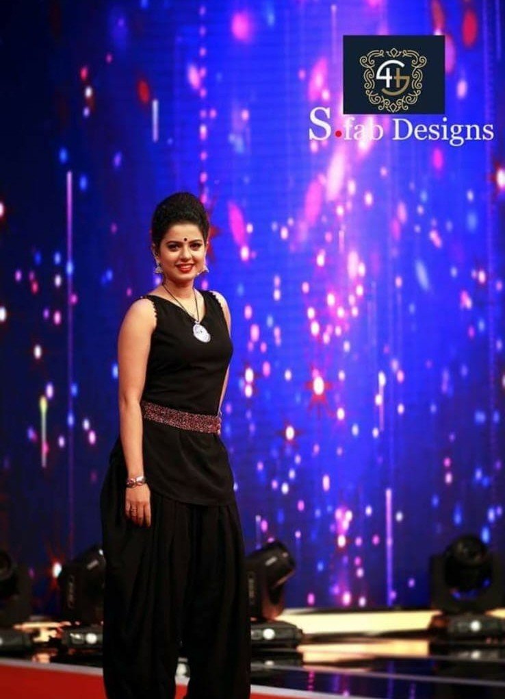 Smitha Haridas on stage in black S.fab Designs outfit